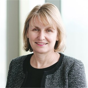 Alison Garrett in a dark top, in front of a window