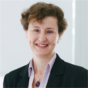 Clare Howard in a black jacket, in front of a pale background