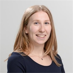 Ella Moss in a dark top, in front of a grey background