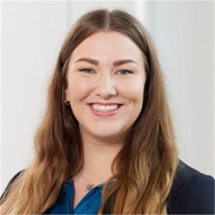 Danielle Godolphin in a dark jacket, in front of a pale background